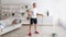 Active lifestyle. Mature man exercising with jumping rope in living room interior at home, panorama, free space