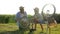 Active lifestyle, Ñurious child and father repairing bicycle at rural on background of nature in backlight