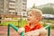 Active little boy on playground. playing child on merry go round.