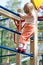 Active little child climbing on a high ladder