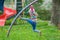 Active little girl climbing monkey bar outdoors on spring playground