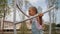 Active little girl riding on carousel spinning around, having fun and happy