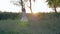 Active little girl runs around and plays with raised arms at countryside at sunset