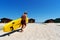 Active male surfer running with surfboard on sand beach enjoying healthy lifestyle extreme sport