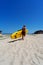 Active male surfer running with surfboard on sand beach enjoying healthy lifestyle extreme sport