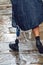 Active male tourist or pilgrim with prosthesis walking on a street of a old town of Santiago de Compostela on a rainy day