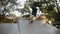 Active man doing skateboard trick on edge of skateboard ramp at skateboard court, stops on the top. Man skating outdoors