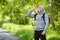 Active man drinking water from a bottle, outdoor. Young muscular male quenches thirst