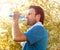 Active man drinking water after outdoor workout