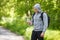 Active man holding a bottle of water, outdoor. Young muscular male quenches thirst