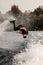 active man jumps and makes flip over the water on wakeboard