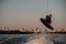 active man making trick in jump with wakeboard over splashing river. Summertime watersports activity