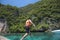 Active man on thai traditional longtail Boat is ready to snorkel and dive, Phi phi Islands, Thailand