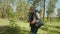 Active mature gray haired backpacker man hiking in summer forest