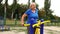 Active mature woman working out with various equipment outdoors on the stadium