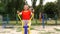 Active mature woman working out with various equipment outdoors on the stadium