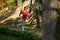 Active middle aged woman, athlete, jogger exercising outdoors, running on city park treadmill on sunny warm summer day