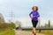 Active middle-aged woman jogging in winter