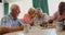 Active mixed-race senior people playing chess game in the nursing home 4k