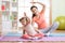 Active mother and child daughter are engaged in fitness, yoga, exercise at home