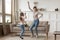 Active mother dancing at home with little daughter