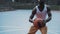 Active Muscly Afro - American Male Basketball Player Finting and Throwing Ball into the Hoop while Playing Basketball at