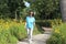 Active older woman walks for exercise in natural setting