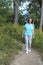 Active older woman walks for exercise in natural setting