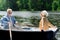 Active pensioners relaxing and rowing the boat while resting