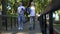 Active pensioners walking in park with yoga mats and water bottles, workout