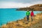 Active people in outdoor activity. Couple tourists hiking in nature with view of Lake Pukaki near Aoraki aka Mount Cook