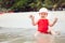 Active playful child playing in water at tropical beach during summer holidays