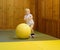 Active preschool boy playing with big ball in indoor sports hall/gym class