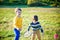 Active preschool girl and boy playing badminton in outdoor court in summer. Kids play tennis. School sports for children. Racquet