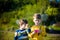 Active preschool girl and boy playing badminton in outdoor court in summer. Kids play tennis. School sports for children. Racquet