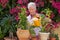 Active retiree gardener watering plants