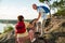 Active senior couple hiking on the top of rock