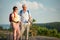 Active senior couple hiking on the top of rock