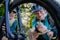 Active senior couple repairing bicycle, pumping up tire in nature in summer.