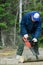 Active senior cutting a fallen tree