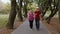 Active senior elderly couple doing cardio morning exercise workout. Man, woman running in city park.
