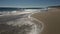 Active senior fisherman fishing on a sandy beach