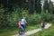 Active senior grandmother with kids riding bikes in nature