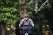 Active senior man with electrobike cycling outdoors on a road in nature.