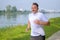 Active senior man jogging along the bank of a river in spring