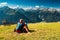 Active senior man watching mountain scenery with grandson