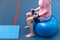 Active senior woman exercising with dumbbell in sports center