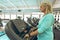 Active senior woman exercising on treadmill in fitness studio