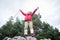 Active senior woman happy hanging from tree in forest