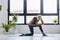 Active senior woman practicing yoga indoors